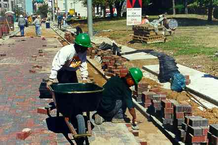 Workers Installing New Concrete Pavers